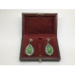 A boxed pair of gold and silver drop earrings set with jade, onyx and diamonds.