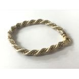An 18carat gold Italian bracelet with woven Simulated rope white and yellow gold bead. Weight 17g