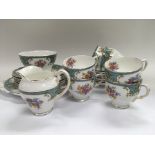 A decorative bone china tea set with transfer printed floral spray patterns.