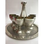 A House of Lawrian silver decanter set comprising a circular tray six cups And decanter London