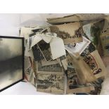 A box containing loose postcards including I world war silk embroidered cards local towns such as