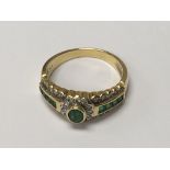 A 18 ct gold ring inset with emeralds and diamonds size L .