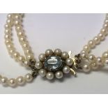 A graduated necklace of pearls set with a 9ct gold Pearl and Aquamarine clasp.