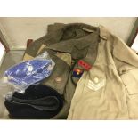 A suitcase containing a collection of army uniform items.