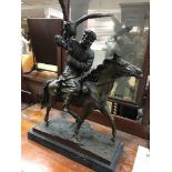A bronze in the form of a hunter on horse back.mounted on a marble base 67 cm