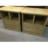 A pair of maple side cabinets the two open sections above two drawers on a plinth base .