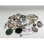 A collection of costume jewellery including an opal stick pin and some silver items.