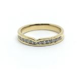 An 18ct yellow gold half eternity ring having a row of thirteen diamonds, approx 0.25ct, ring size