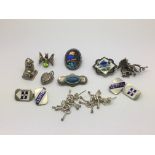 A small collection of silver and enamel brooches, cufflinks etc.