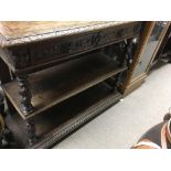 A oak two tier buffet the raised top enclosing a marble top fitted with two drawers flanked by