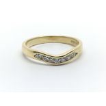 An 18ct yellow gold wishbone shaped ring with seven diamonds, approx 0.25ct, ring size approx O