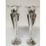 A pair of silver vases of hexagonal tapering shape with circular Loaded bases Birmingham hallmarks