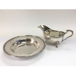 A silver sauce boat and a silver dish, different assays (2).