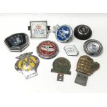 A collection of ten various old car badges including AA and RAC