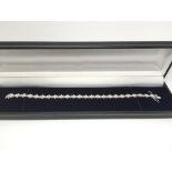 A boxed 18ct white gold daisy style diamond line bracelet, diamonds approx 5.20ct, approx 15.8g.