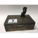 A hallmarked silver cigarette box together with a heavy hallmarked silver parrot figure.