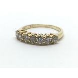 An 18ct yellow gold and diamond half eternity ring having a row of seven diamonds, approx 0.66ct, ri