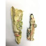 An ivory clip in the form of an Oriental mother and child together with a carved ivory flower (