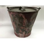 A vintage copper and brass fire bucket.
