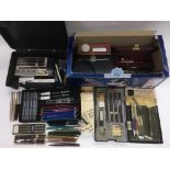 A collection of pens and drawing implements including Parker pens.