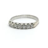 An 18ct white gold and seven stone diamond ring, approx 0.33ct, ring size approx S/T