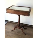 A mahogany hinged top display case on stand bearing brass plaque reading ‘Presented to the Museum of