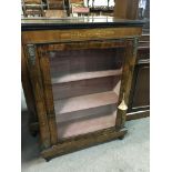 A Victorian inlaid walnut piere cabinet with gilt metal mounts and a lined interior with key.