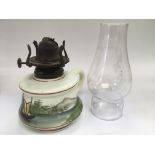 An antique painted glass finger oil lamp depicting a boat on a river.