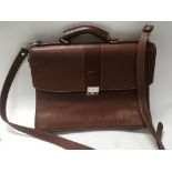 A brown leather Burberry satchel.