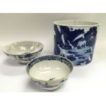 Four blue and white ceramic items comprising a scalloped dish and cover, two bowls and a vase, all
