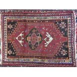 A small Persian wool rug 122 x 129cm