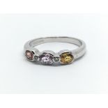 A 9ct white gold and coloured multi stone ring, ring size approx L/M