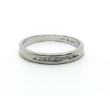 A platinum half eternity ring with a row of seven small diamonds, ring size approx J