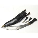 A military Gurkha Kukri knife with wooden handle, skinning knife and sharpener in sheath with belt