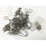 A bag of mixed sterling silver chains.