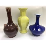 Three monochrome Oriental vases of different shapes and colours, largest approx 31cm tall.