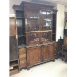 A large, George III style reproduction breakfront bookcase with cupboard base and side drawers