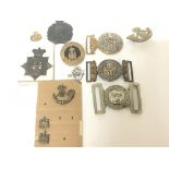 A collection of Essex Regimental belt buckles including West Essex 56 other hat badges and lapel