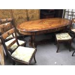 An Italian dining table the oval top with floral marquetry design the shaped legs with stylised rams