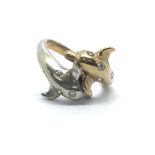 A 9ct yellow gold ring in the shape of two dolphins with ten inset diamonds, ring size approx M/N