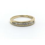 An 18ct yellow gold half eternity ring having nine diamonds, ring size approx L/M