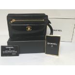 A Genuine and guaranteed Chanel black leather clut