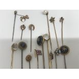 A collection of 15 stick pins including gold.