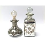 Two glass scent bottles with silver plated decoration and glass stoppers, largest approx 17cm tall
