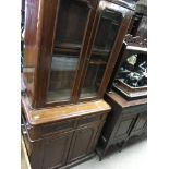 A Victorian mahogany bookcase fitted with two drawers and cupboards under on a plinth base .86 cm By