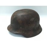 German WW2 style M35 steel helmet with camp paintwork, complete with liner, service worn