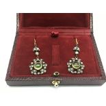 A boxed pair of drop earrings set with peridots, s