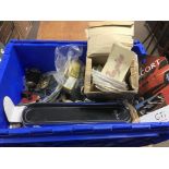 A box of assorted car parts, badges and decals including unused Ford special edition stickers.