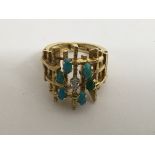 A 18 ct gold contemporary ring Inset with turquoise stones and a single diamond size H 11 grams .