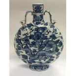 A blue and white moon flask decorated with dragons and with character marks to the base, approx
